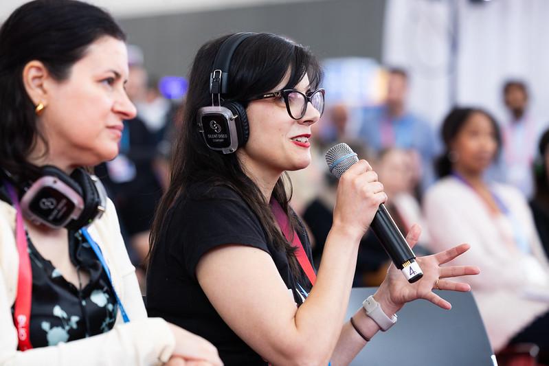 ONE Conference attendees admiring someone using a VR headset