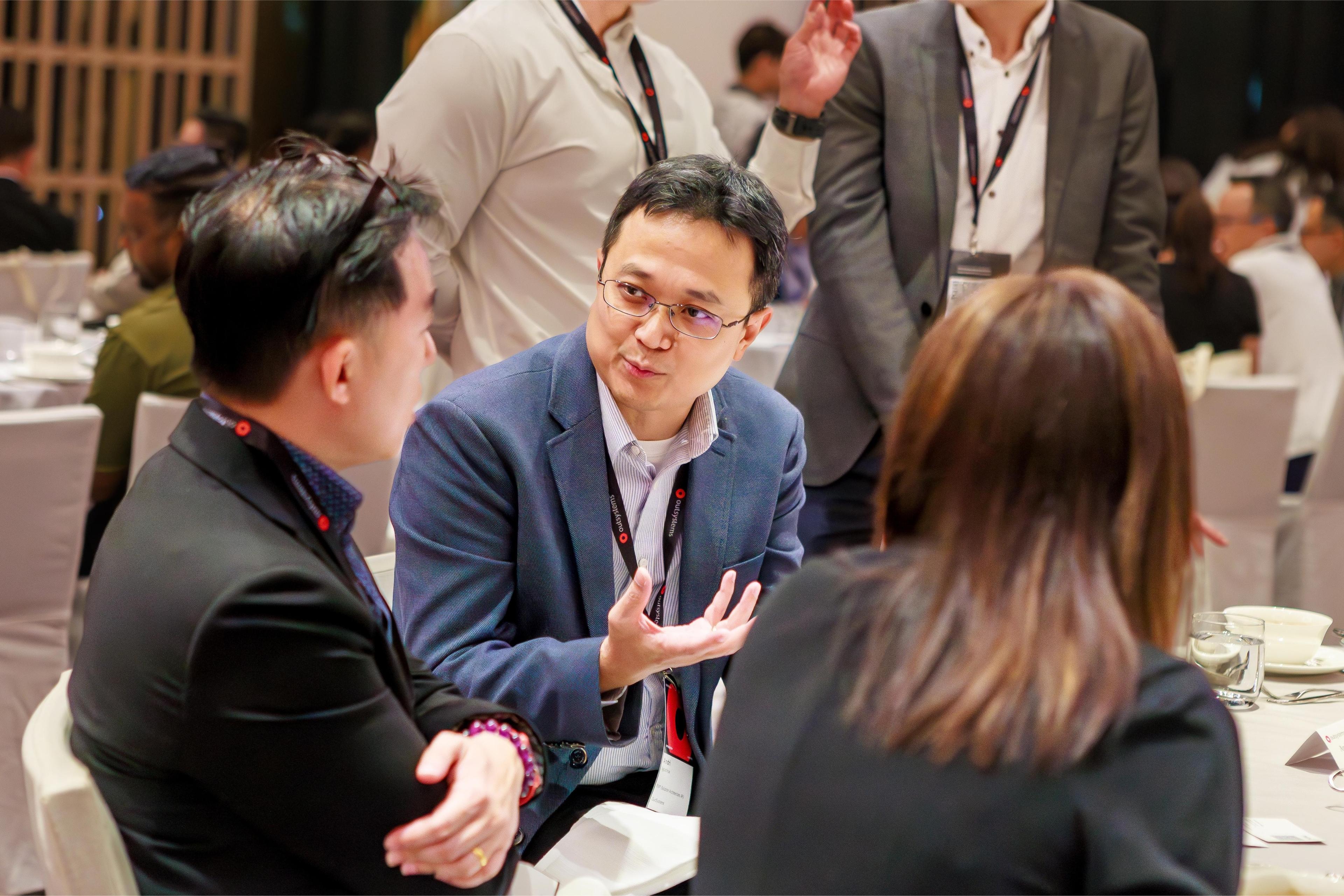 ONE Conference attendees admiring someone using a VR headset