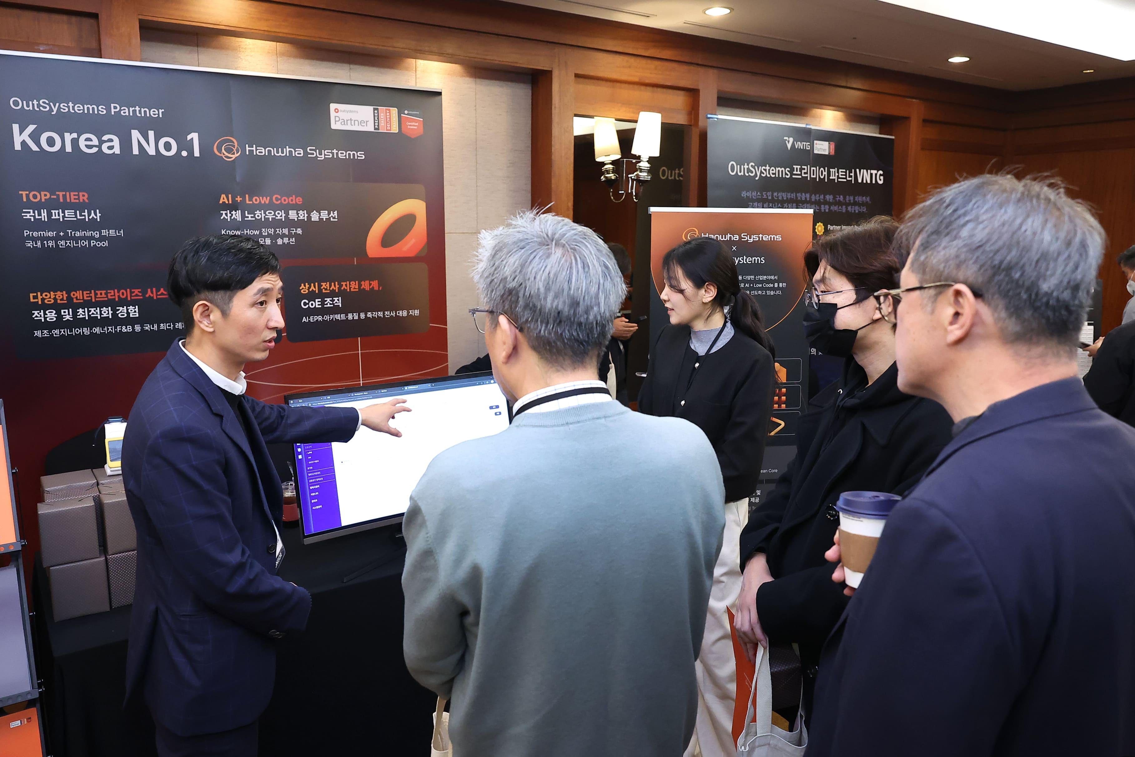 Attendees walking in front of a ONE Conference Ad